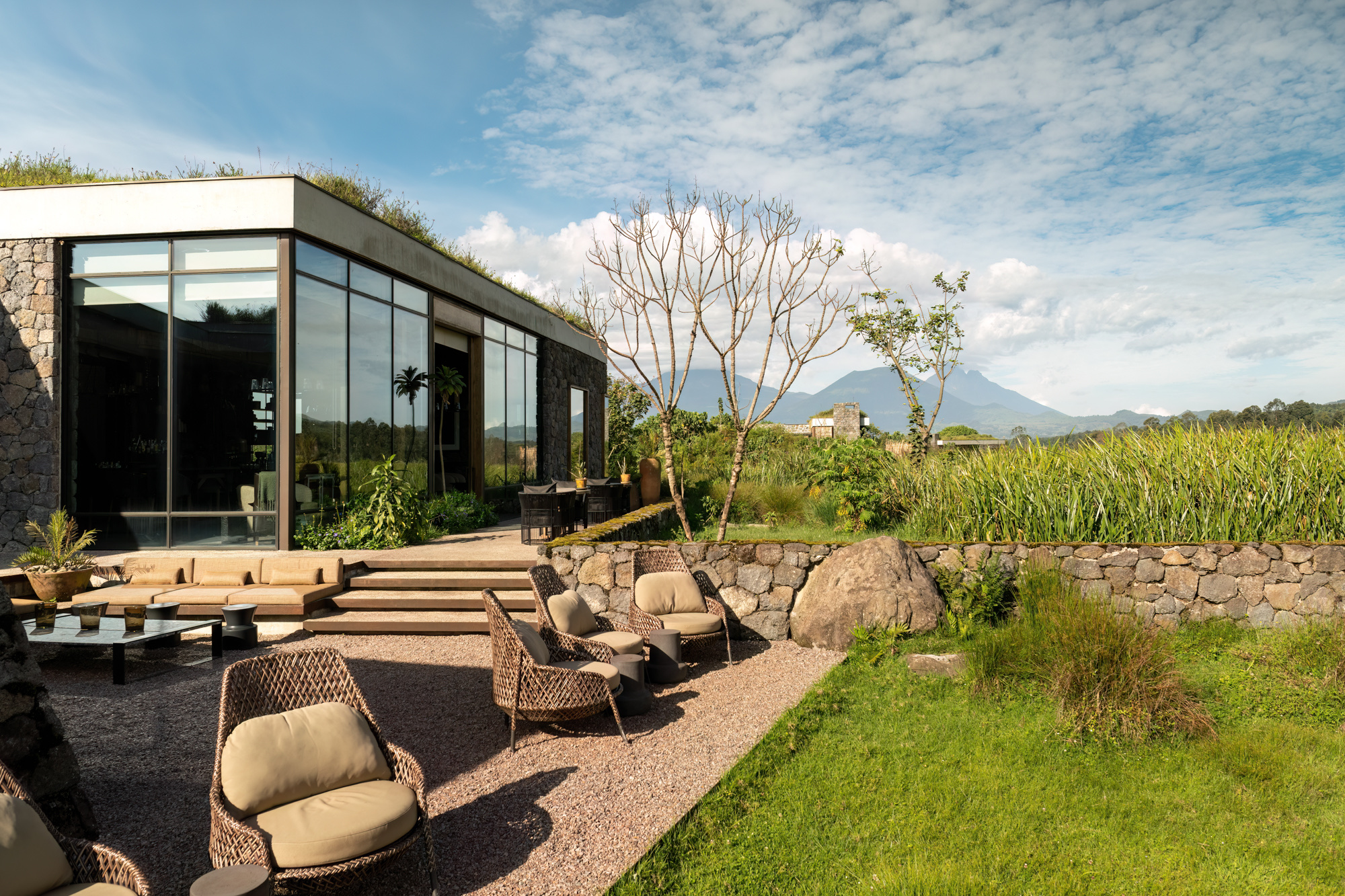 Lodge building with a planted roof and terrace facing the volcanoes — Singita Kwitonda Lodge, Volcanoes National Park, Rwanda