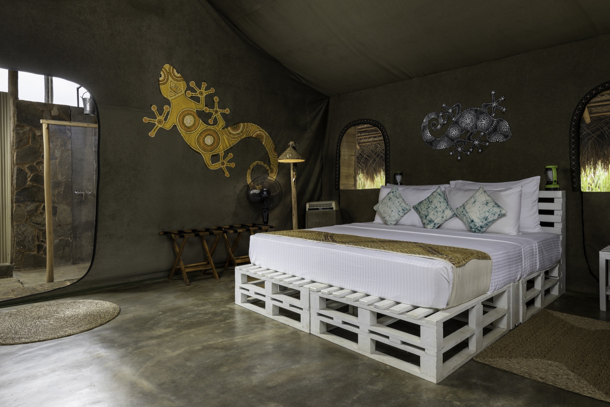 Family Tent bedroom with king bed and a Vedda-inspired gecko motif on the canvas wall