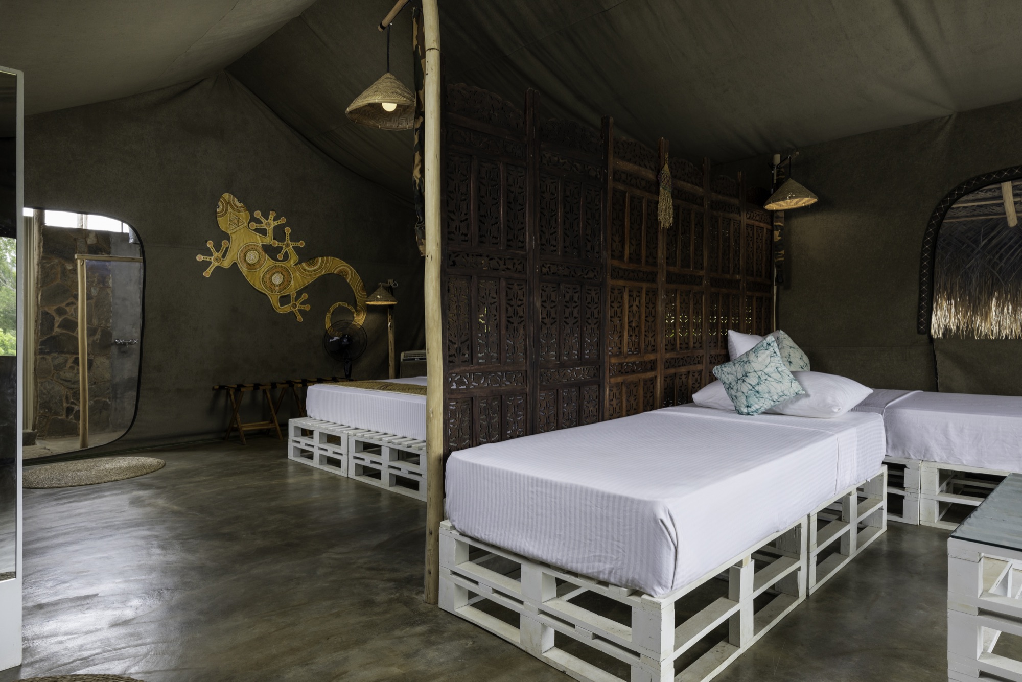 Family Tent twin beds separated from the main bedroom by a carved wooden divider