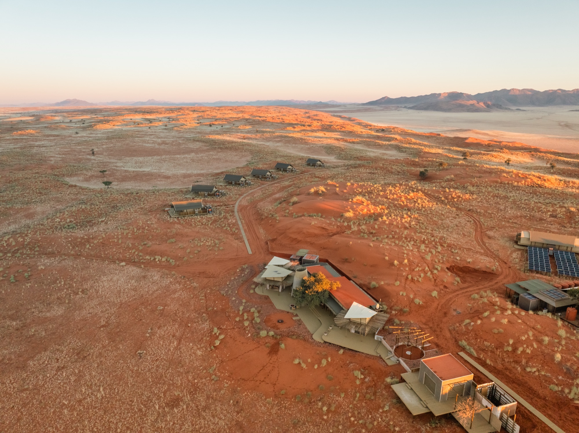 Aerial view of the camp's main area and tents on the red sand
