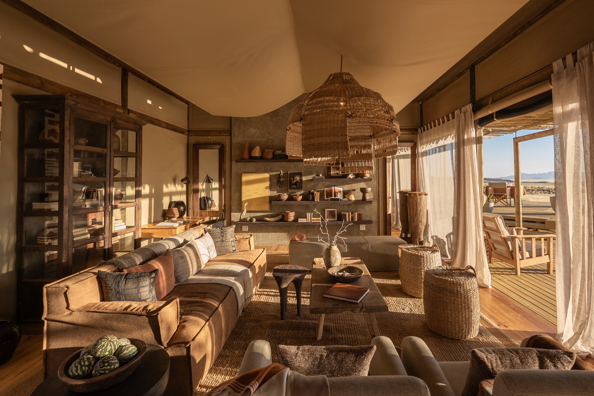 Leather sofas, shelves and wicker lamp in the main lounge