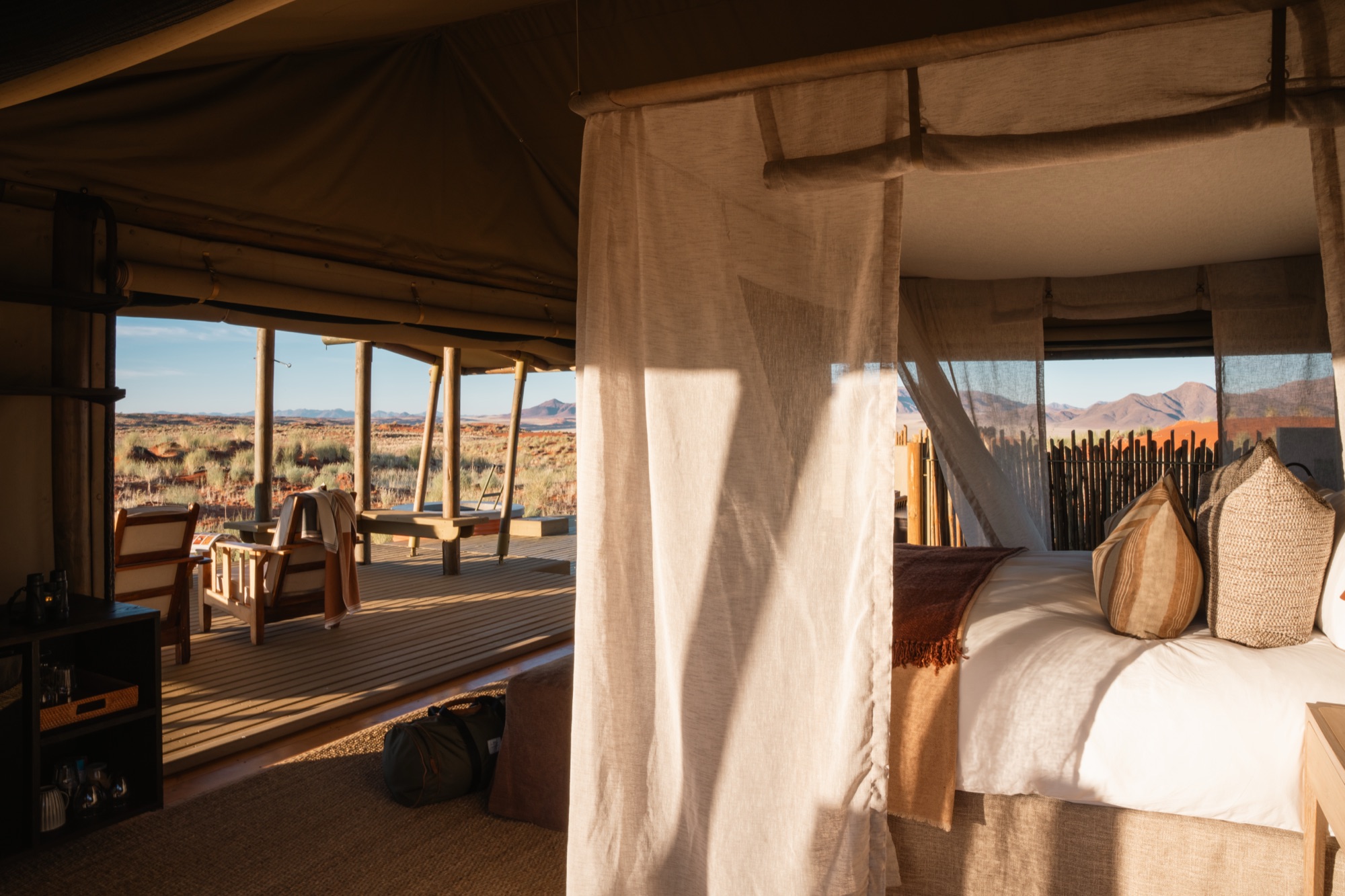 Tented room bedroom with a mosquito net and views onto the deck