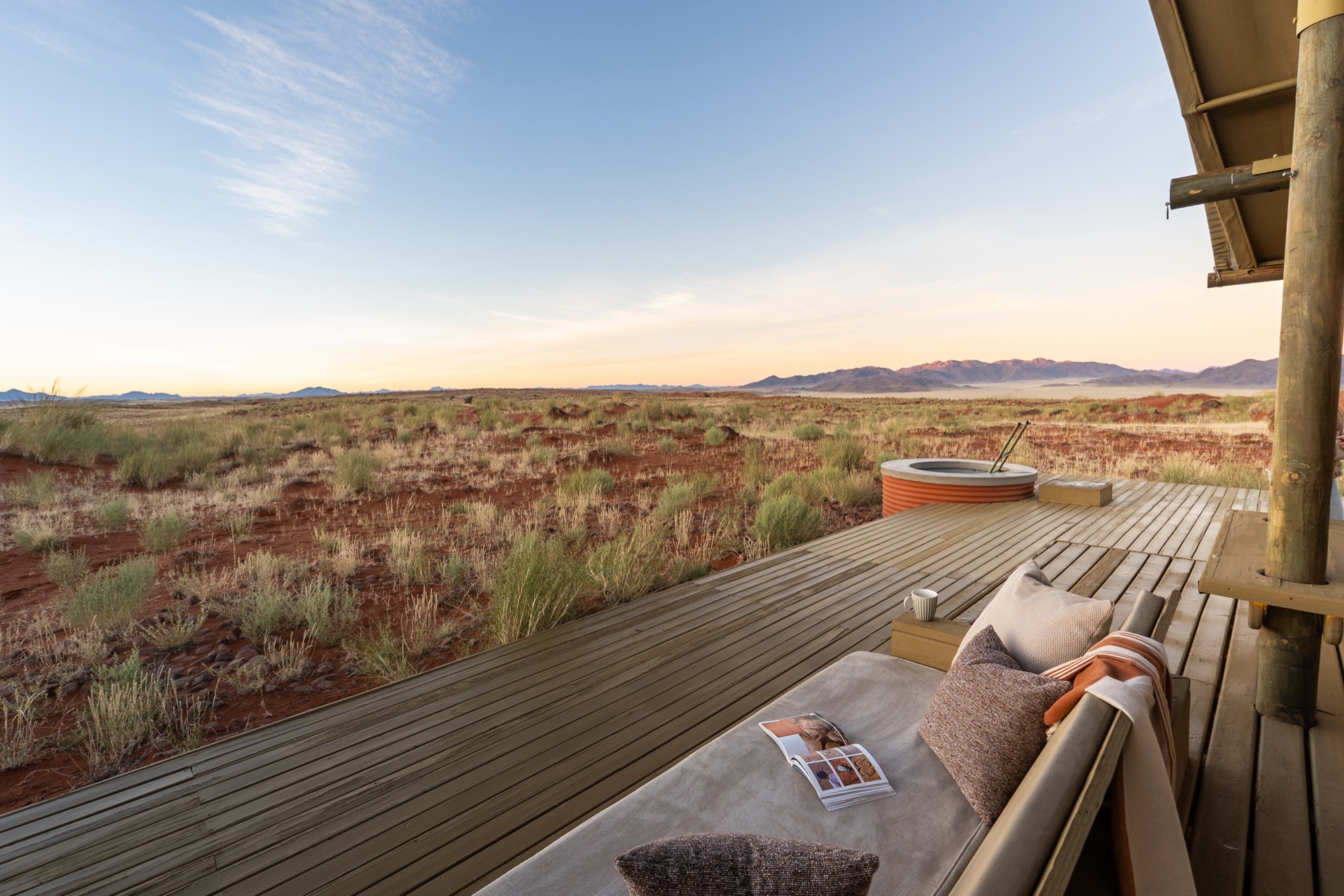 Deck daybed facing the grassland, with the water silo behind