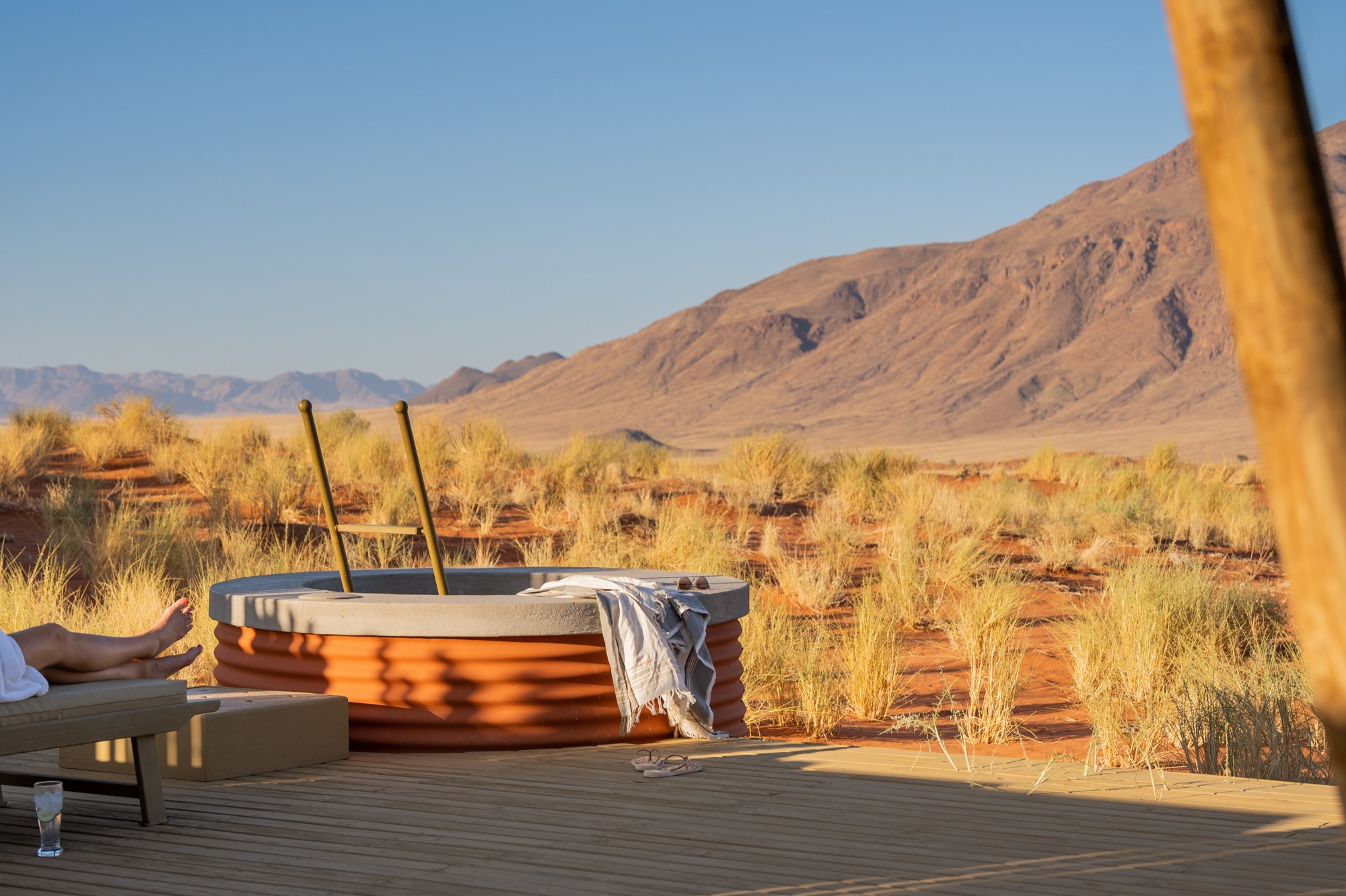 Small water-filled silo on a deck facing a mountain