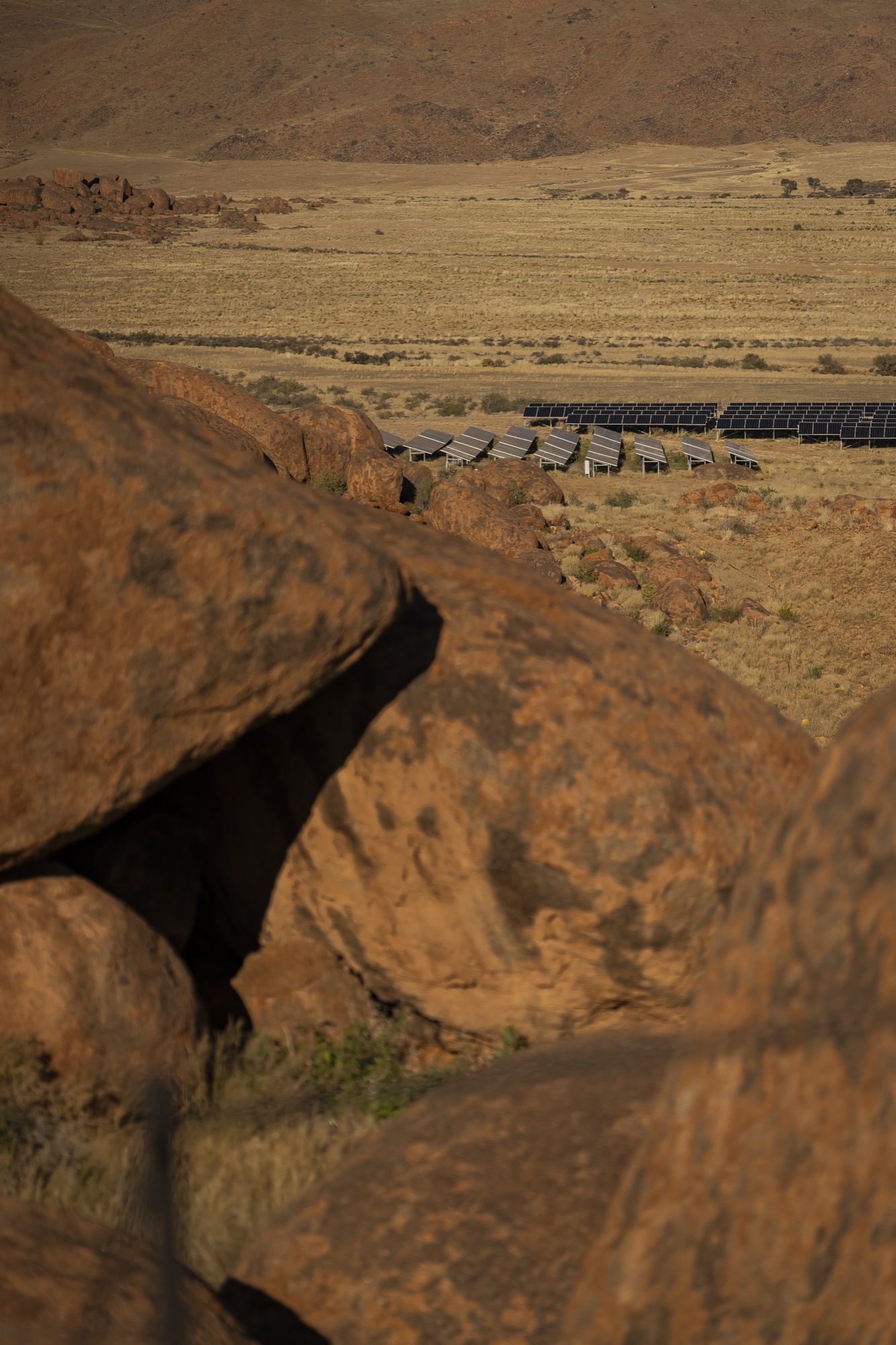 The lodge's granite boulders seen from above, the plains beyond