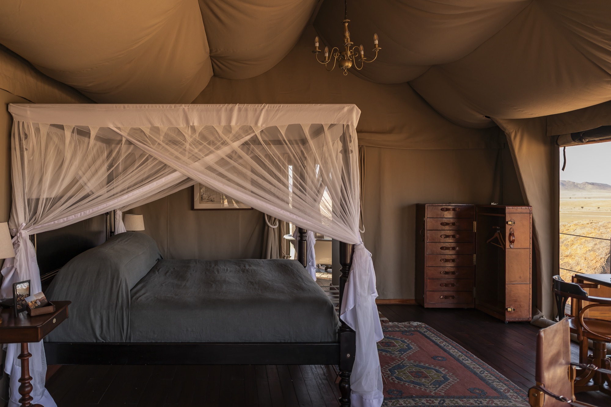 Bed with a mosquito net in a canvas tent